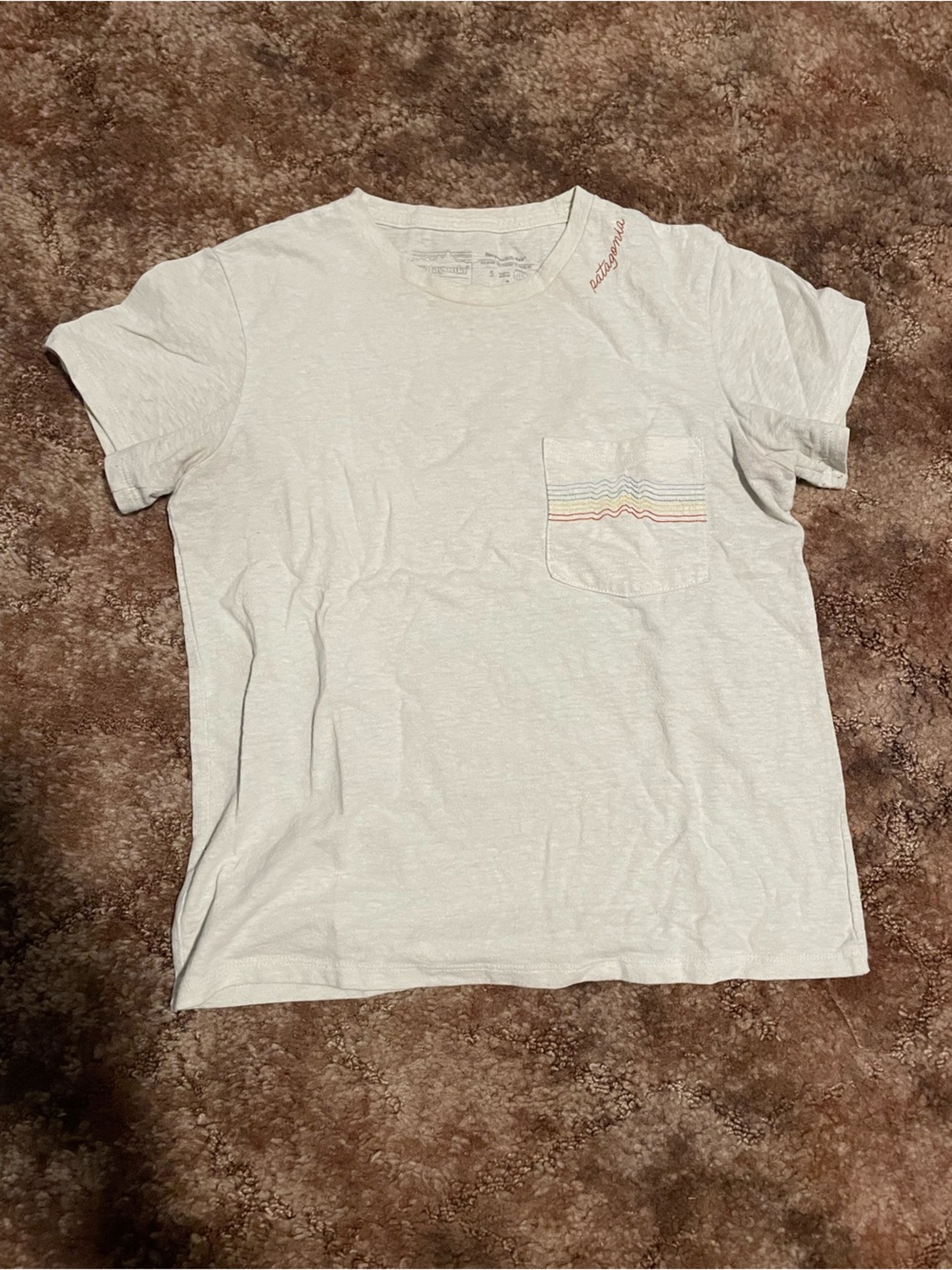 Patagonia light gray crop top with rainbow pocket detail